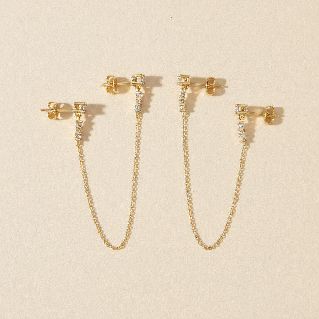 ✨ 18k Gold Filled CZ Double Piercing Chain Earrings — Two Studs. One Chain. The Ear Stack Elevated.